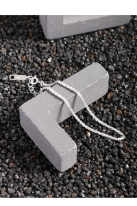 Macro shot of S925 sterling silver chain featuring lobster clasp and extension links