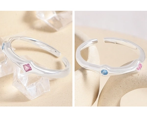 Detail of S925 sterling silver ring with blue and pink cubic zirconia and adjustable band