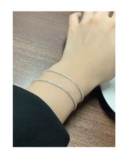 Close-up of S925 sterling silver layered bracelets with sparkling textured finish