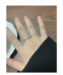 Detailed top view of S925 silver ring set with blue and pink cubic zirconia accents