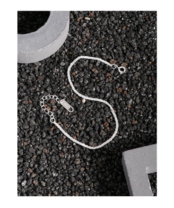 Close-up of S925 sterling silver cauliflower chain with lobster clasp on black stones