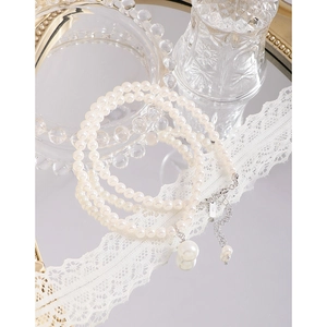 Three-layer faux pearl necklace with silver lobster clasp and large pearl pendant on lace