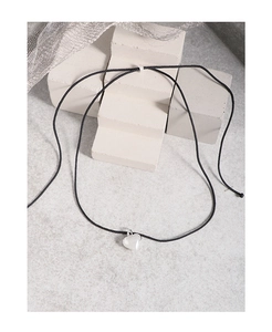 Détail du pendentif cœur en argent S925 sur cordon noir avec base en pierre minimaliste