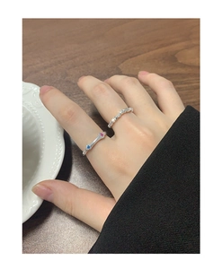Close-up of S925 silver rings with micro-set colorful zircons on a female hand