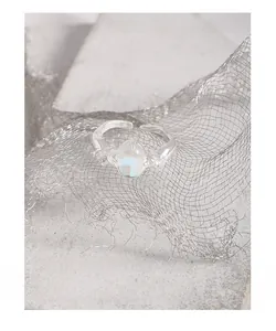 Detailed close-up of S925 silver irregular ring with oval moonstone and side diamonds
