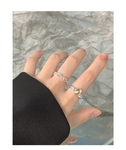 Detail of silver S925 moonstone ring set with chain knots and sparkling side diamonds