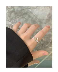 Detail view of a silver irregular line ring with a yellow oval moonstone and side diamonds