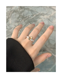 Detailed view of an S925 silver ring featuring an oval moonstone on a textured background