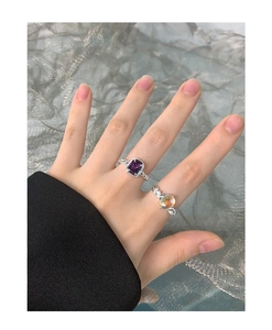 Detail view of S925 silver rings with square purple stone and round moonstone