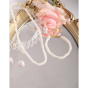 Set collana e bracciale di perle naturali in argento S925 su uno specchio vintage