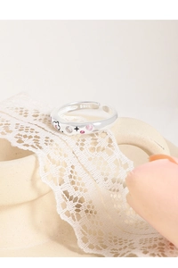 Detail of S925 silver ring featuring pink zircons and delicate star flower engravings