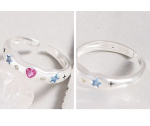 Detail of S925 silver ring featuring blue star and pink heart zircon stones and hallmark
