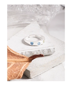 Detail of S925 silver adjustable ring with blue heart-shaped cubic zirconia on stone plates