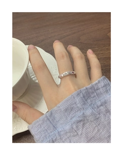 Close-up of S925 silver ring with pink zircon flowers and stars on female hand