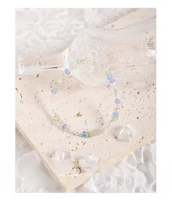 Detail of S925 silver clasp and colorful faceted crystal beads on textured stone