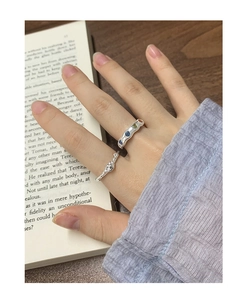 Close-up of stacked S925 silver rings with colorful zircon inlay on model fingers