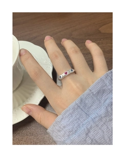 Detail of S925 silver wave ring with colorful heart and star zircons on woman's finger