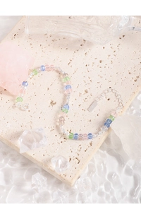 Macro shot of S925 silver tag and colorful faceted crystal beads on light stone