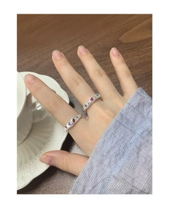 Macro detail of S925 silver rings with colorful zircon inlays on model hand