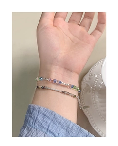 Detail of layered S925 silver bracelet with multi-color faceted crystals on wrist