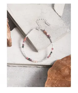 Macro detail of S925 sterling silver lobster clasp and colorful tourmaline beaded bracelet