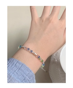 Detail of colorful crystal beaded bracelet with silver spacers on woman's wrist