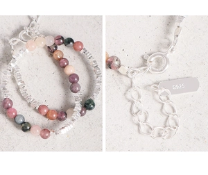 Macro shot of S925 sterling silver stamp and colorful tourmaline beads on a thin bracelet