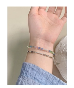 Detailed shot of two layered beaded bracelets with colorful crystals and silver accents
