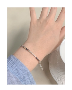 Detailed view of a slender S925 silver bracelet with colorful tourmaline beads on a wrist