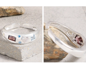 Macro detail of S925 sterling silver stamp and colorful zircon stones on wave ring