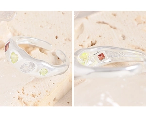 Macro shot of S925 sterling silver hallmark on adjustable ring with colorful zircons