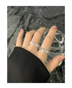 Close-up of S925 silver rings with heart shapes and colorful zircon stones on model hand