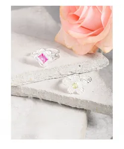 Detailed view of S925 silver rings featuring rose zircon flower and yellow daisy designs
