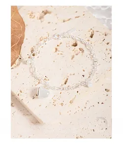 Detail view of S925 sterling silver chain bracelet with heart pendant on stone