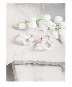 Detailed macro of S925 sterling silver floral rings with pink and purple zircon stones