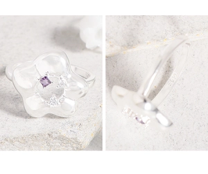 Detailed macro of S925 sterling silver stamp and zircon flower ring with purple stone