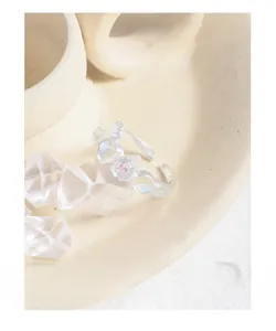 Detailed macro view of S925 sterling silver bow and heart ring with moonstone inlays