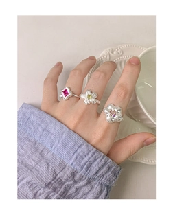 Detailed view of floral S925 silver rings set with colorful zircon stones on hand