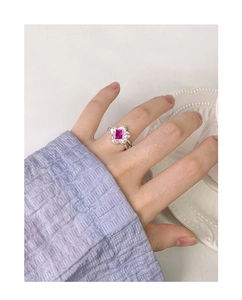 Macro detail of rose red zircon flower ring in S925 sterling silver on finger