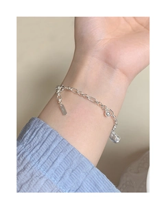 Macro shot of S925 sterling silver chain bracelet with irregular teardrop pendant