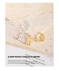 Close-up of gold and silver S925 sterling silver intertwined knot hoop earrings