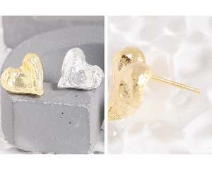 Detailed close-up of S925 sterling silver stamp and irregular hammered texture heart stud