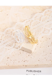 Detailed macro view of S925 sterling silver stamp on interlaced gold and silver earrings