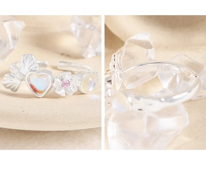 Detailed view of S925 sterling silver bow ring with heart moonstone and pink gem inlay