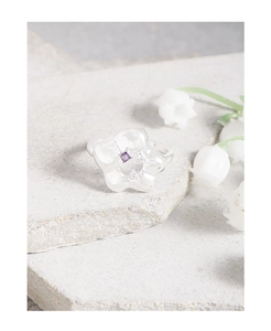 Macro shot of S925 sterling silver flower ring with purple gemstone and zircon details
