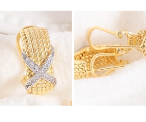Detail of twisted rope gold earring with X-shaped zircon pave and S925 hallmark stamp