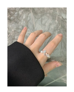 Detail of S925 silver ring featuring a moonstone heart, bow design, and flower accents