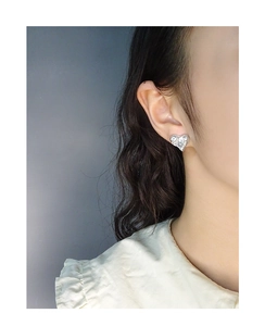 Close-up of S925 sterling silver heart earring with textured melting wrinkle finish