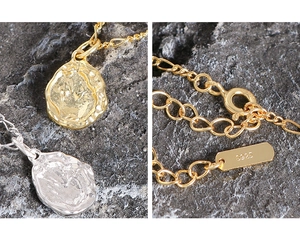 Detail view of S925 sterling silver stamp and irregular lava texture on necklace pendants
