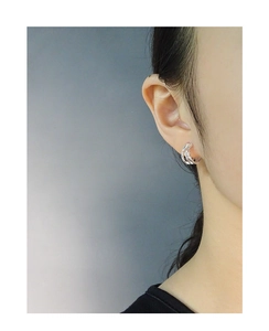 Detailed side view of S925 sterling silver multilayer crisscross hoop earrings on ear